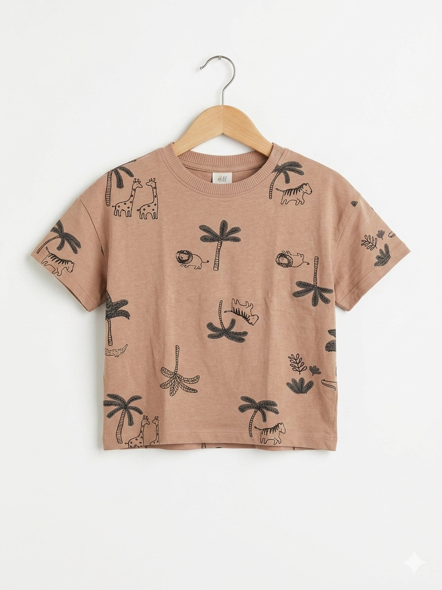 Front view of an H&M brand brown short-sleeved t-shirt for infants, featuring a continuous pattern of black outline drawings of safari animals like giraffes, zebras, lions, and palm trees. It is hanging on a wooden hanger.