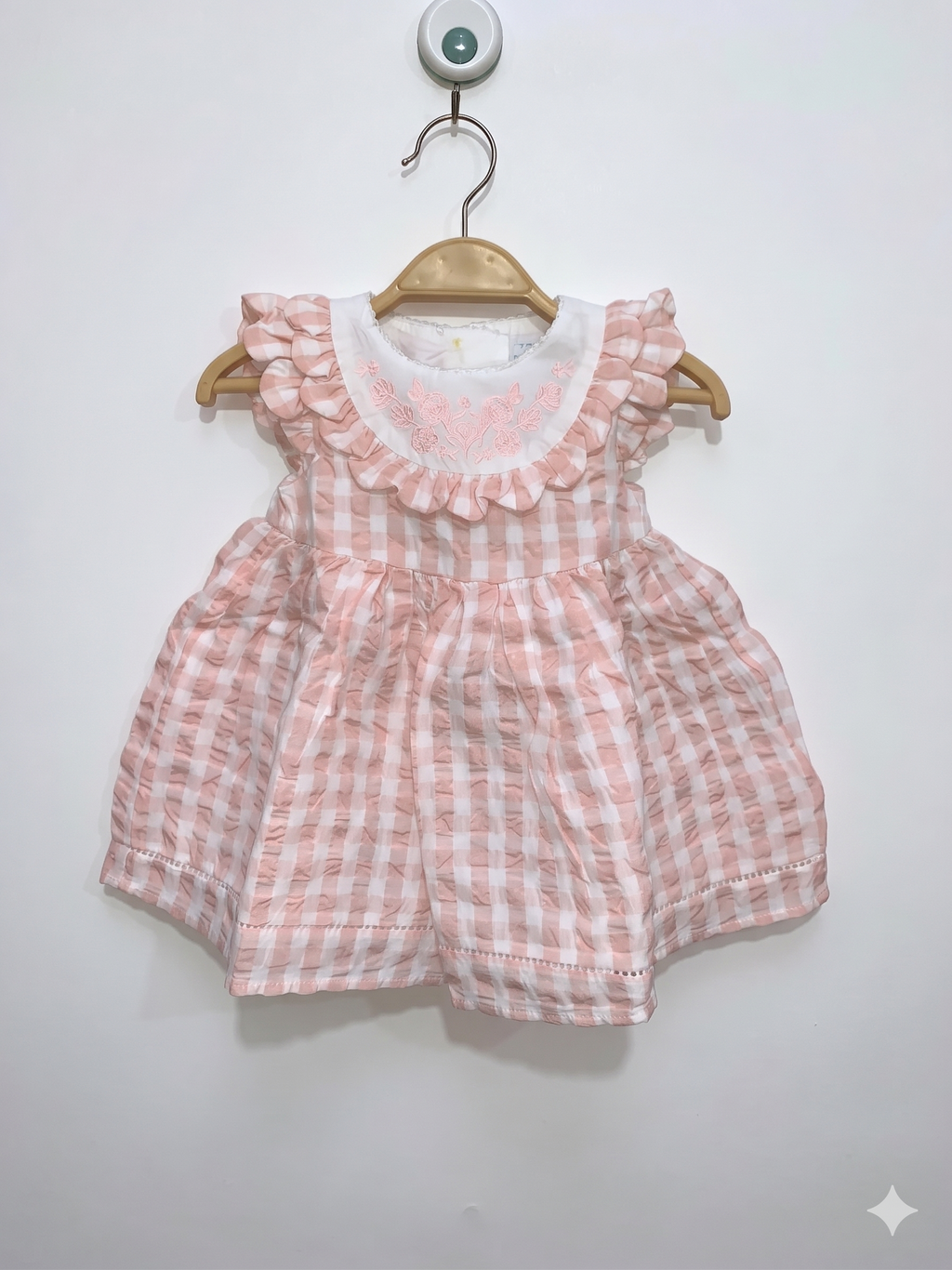 Front view of a Tahari baby girl dress in peach gingham with a white ruffled embroidered collar.