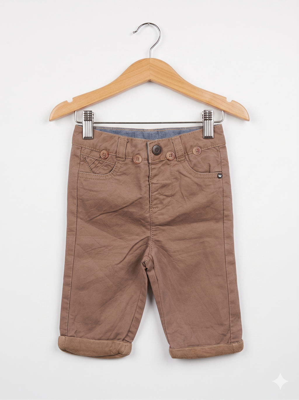 Front view of Orchestra baby boy khaki chino trousers featuring decorative buttons and rolled cuffs.