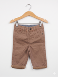 Front view of Orchestra baby boy khaki chino trousers featuring decorative buttons and rolled cuffs.