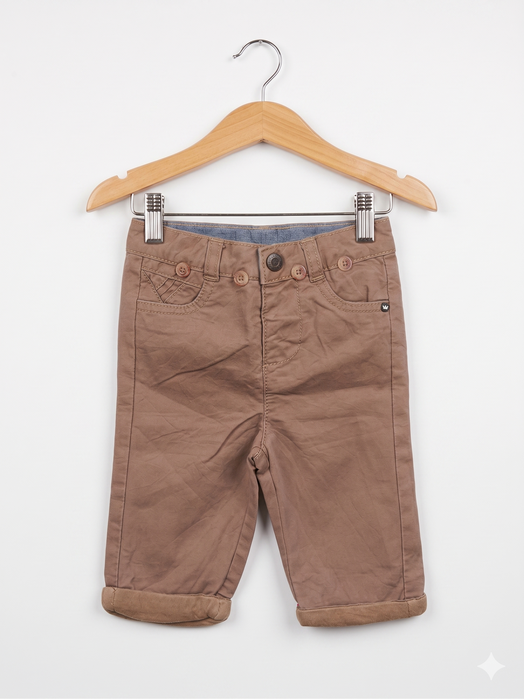 Front view of Orchestra baby boy khaki chino trousers featuring decorative buttons and rolled cuffs.