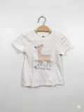 Front view of Topomini baby girls white t-shirt with pink polka dots and embroidered deer graphic on a hanger.
