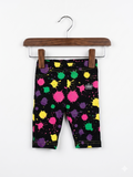 Baby girls white leggings by Carter's with a colorful pink and blue floral pattern throughout, size 9 months, displayed on a pink hanger.