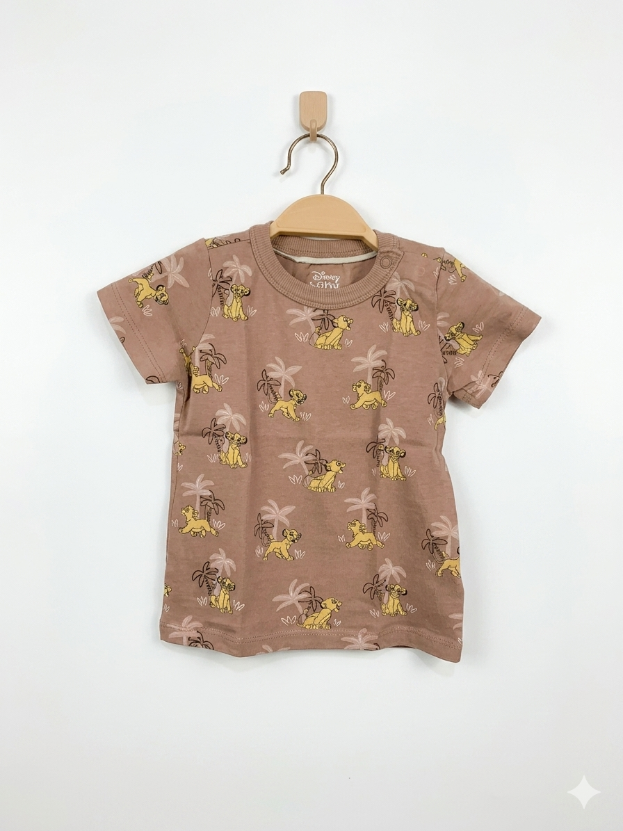 Celebrate a classic with this Disney Baby Lion King Simba T-shirt from the premium European brand C&A. This mocha-colored tee features a stylish all-over Simba print, making it a standout piece for any toddler. Made from soft, organic cotton, it ensures all-day comfort for your 12-18 month old. Perfect for Disney fans looking for high-quality, sustainable thrift finds. Shop the Disney x C&A collection at Tiny Thrift Store.