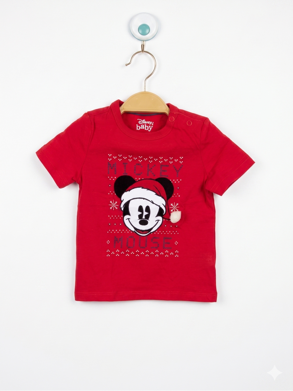 Front and back view of a red infant t-shirt featuring Mickey Mouse in a Santa hat with a white pom-pom. The shirt is displayed on a hanger in front of a Tiny Thrift Store backdrop.