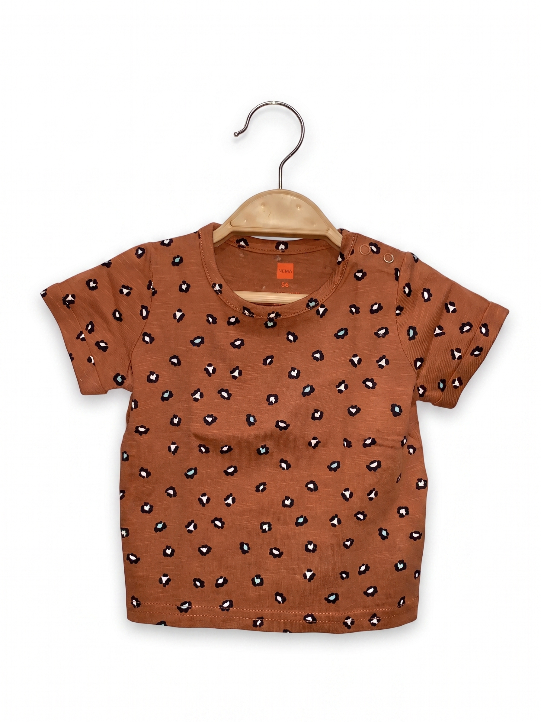 Front view of HEMA baby t-shirt in terracotta brown with black and white leopard print and shoulder buttons.