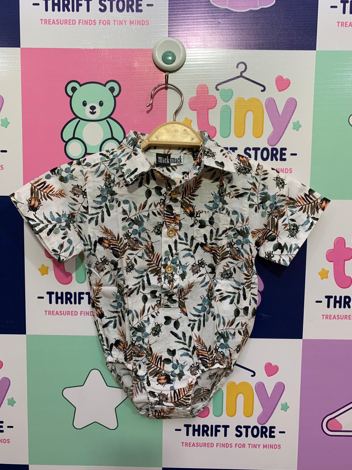 Mick Mack Ltd. baby boy short sleeve romper shirt in white, featuring a detailed green leaf and brown beetle print, button-down collar, size 6-9 months.