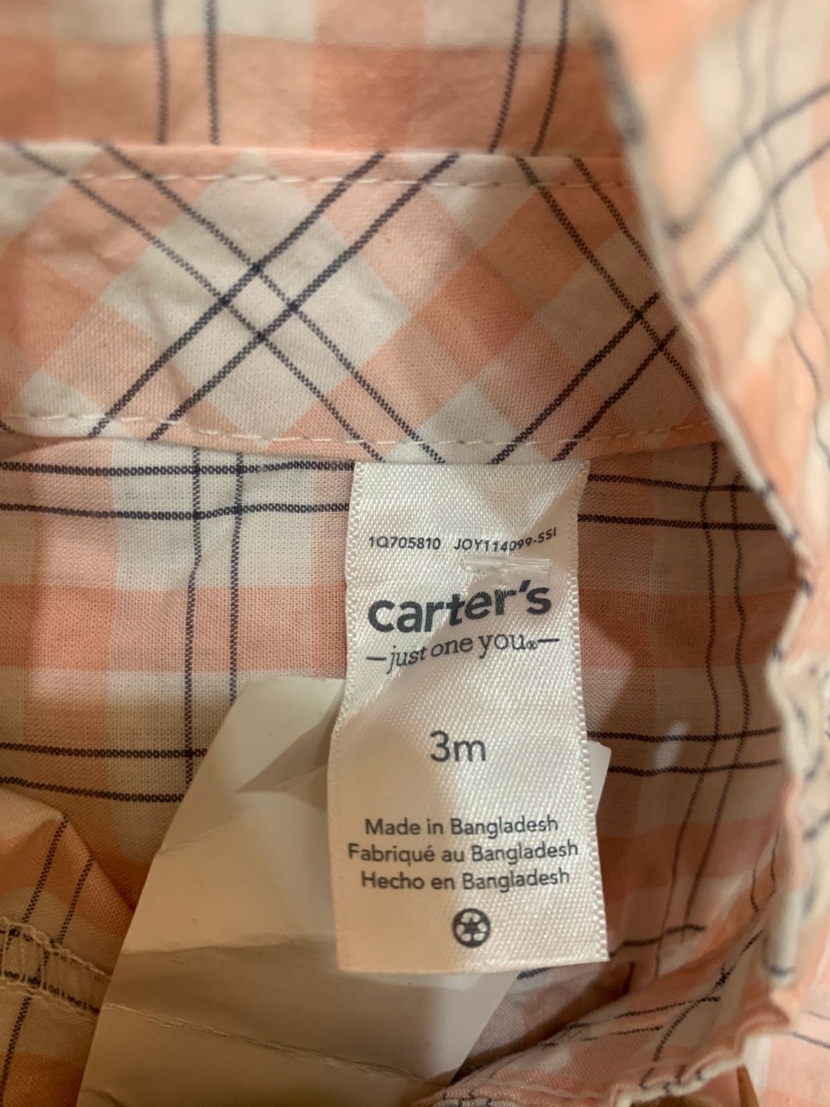 Close-up of the "Carter’s Just One You" neck label, clearly showing the size "3m" and fabric origin.