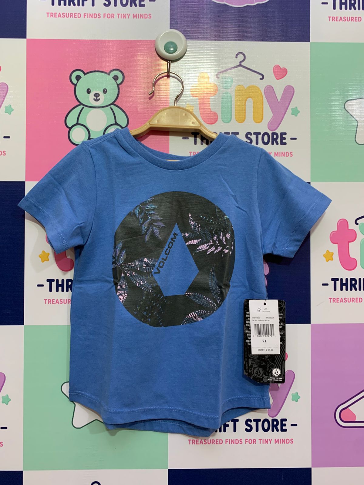 Front view of a blue Volcom toddler t-shirt with a black circular tropical graphic logo, brand new with original price tags, displayed at Tiny Thrift Store.