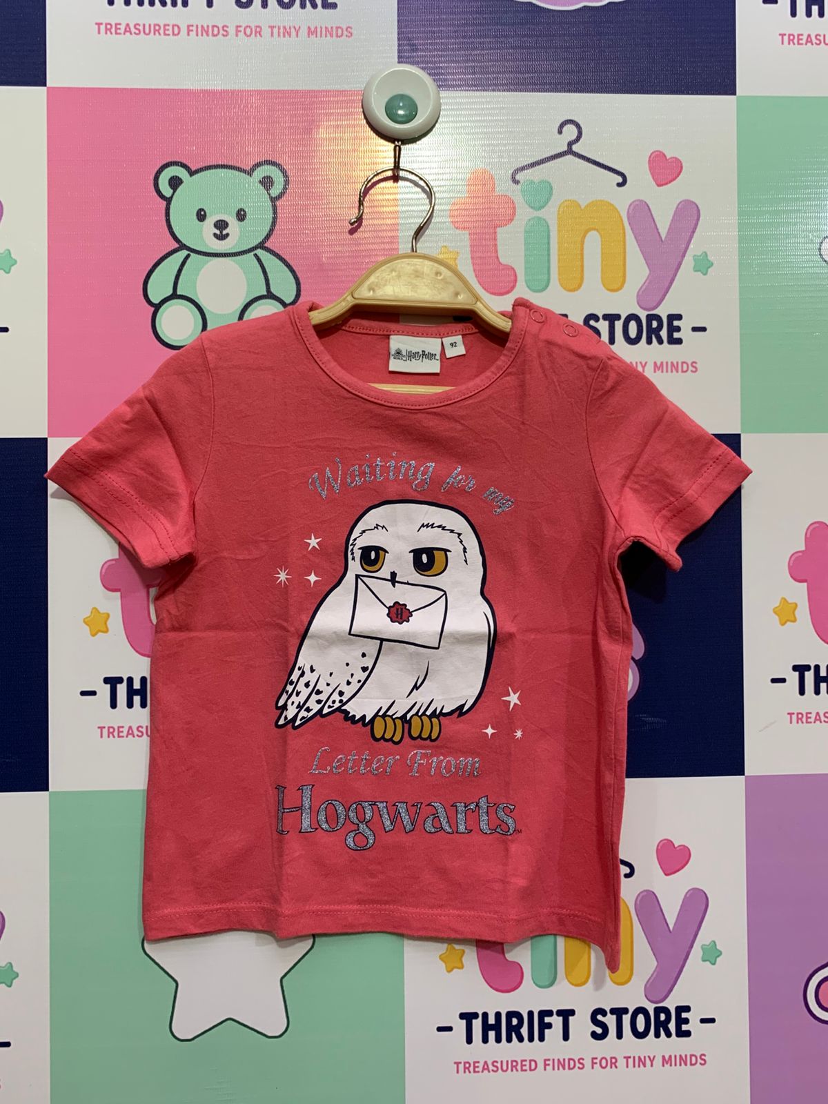 Front and back of a Birba Harry Potter coral pink baby girl t-shirt with Hedwig the owl graphic and "Waiting for my letter from Hogwarts" text