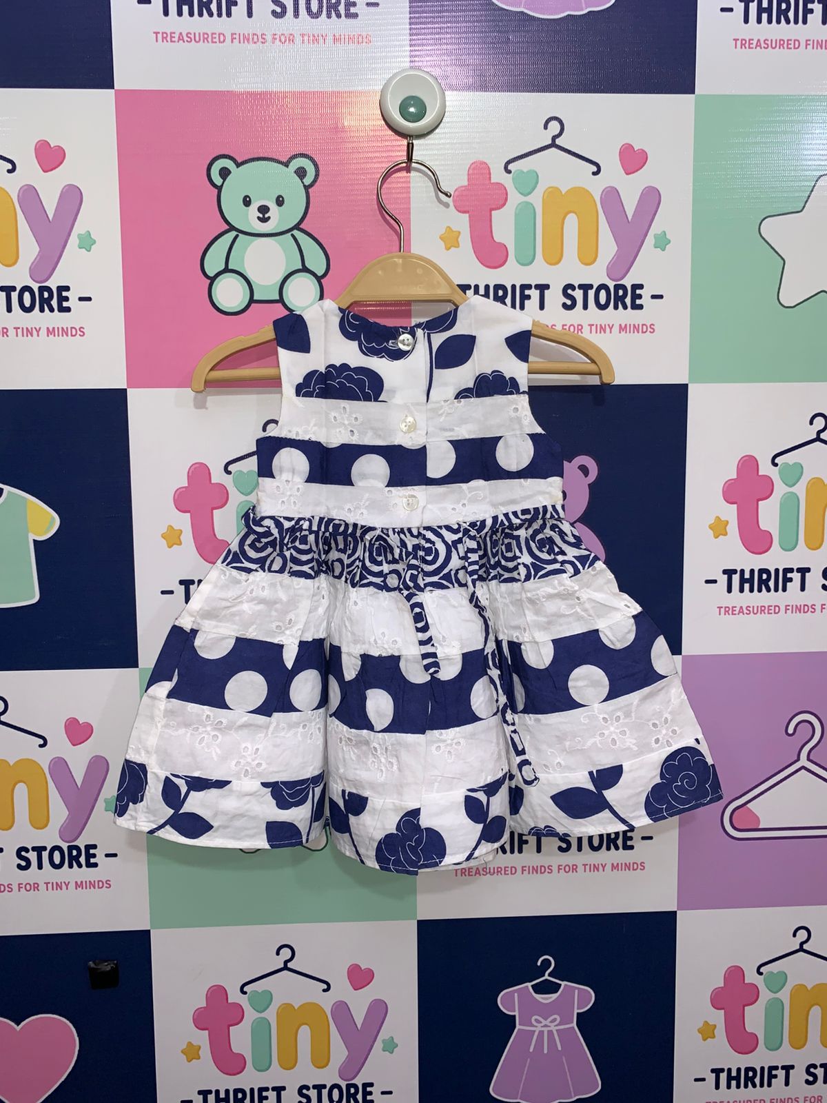 Rear view of Youngland Baby dress showing button closures and navy blue waist tie strings.