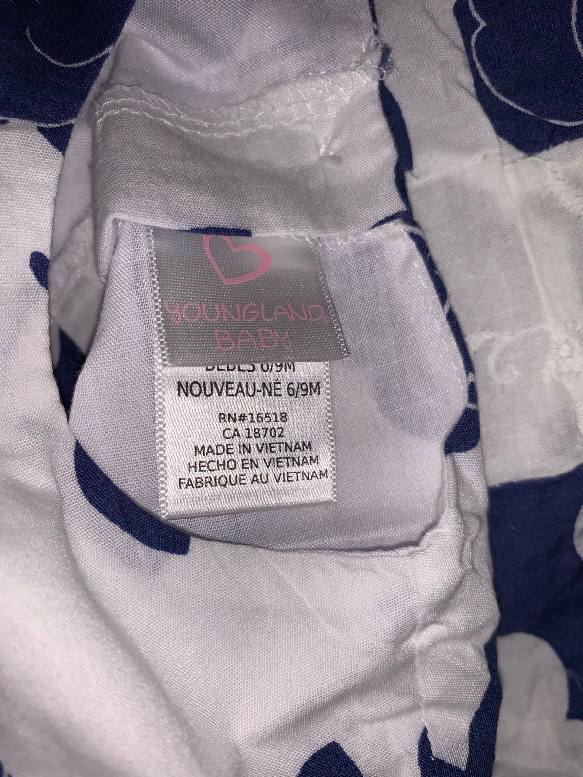 Close-up of Youngland Baby brand label and size tag for 6/9M, manufactured in Vietnam.