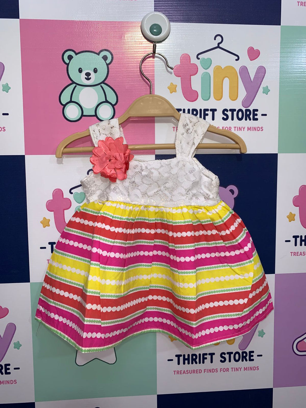 Real Love baby girls dress featuring white lace bodice with a pink flower and vibrant striped skirt.