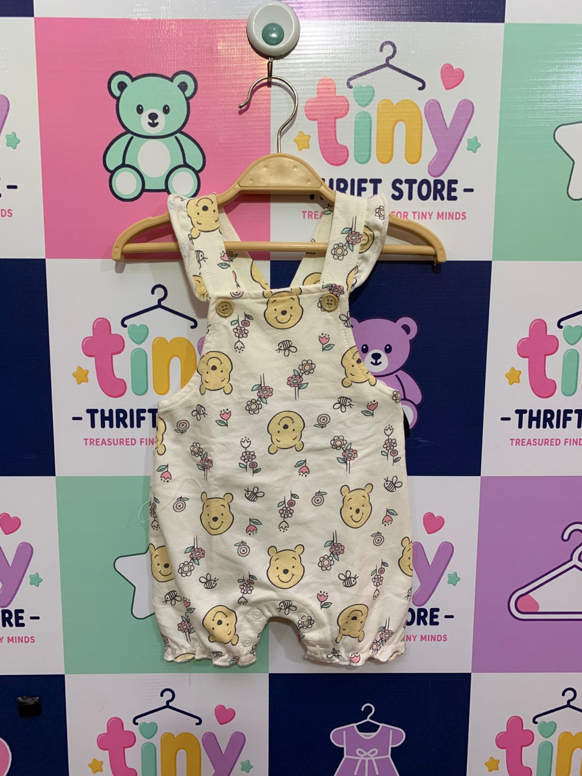 Disney Baby Winnie the Pooh cream overalls with floral print and ruffle straps for baby girls.
