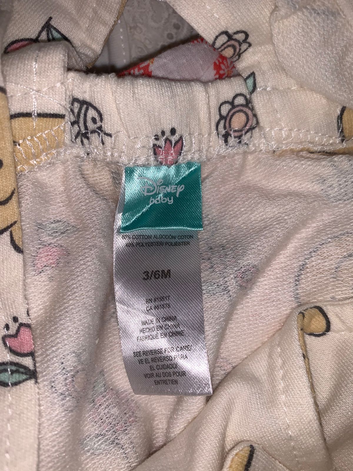 Disney Baby authentic brand tag showing size 3/6M and cotton-polyester fabric blend.
