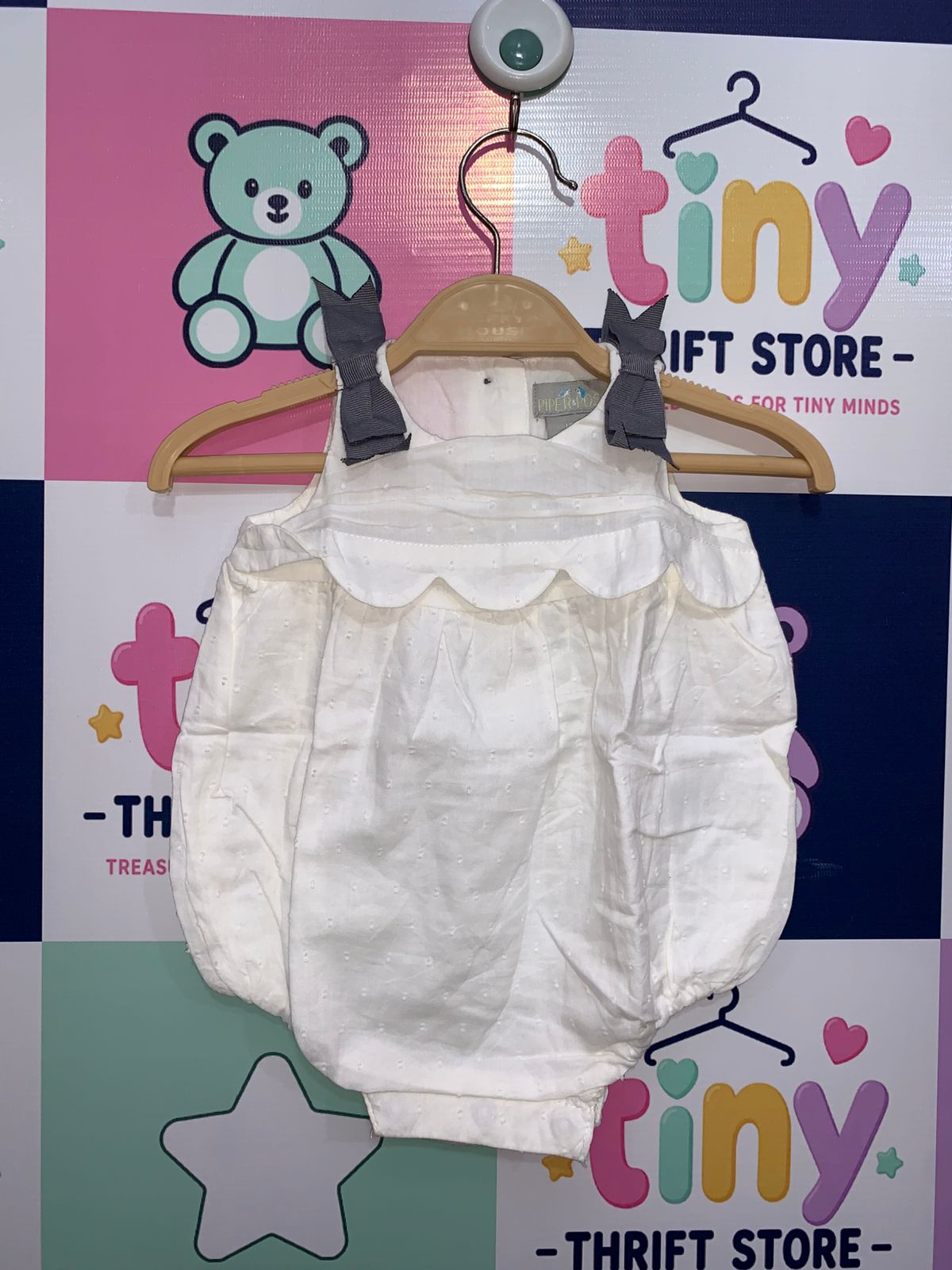 Piper & Posie baby girl 0-3 months white eyelet bubble romper with grey shoulder bows, scalloped detail infant sunsuit, professional studio shot.